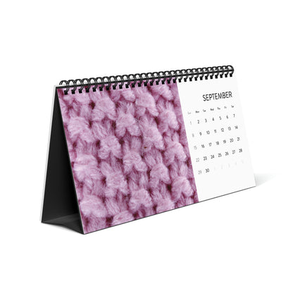 A pink knitted Crochet Addicts - Desktop Calendar perfect for crochet lovers.
