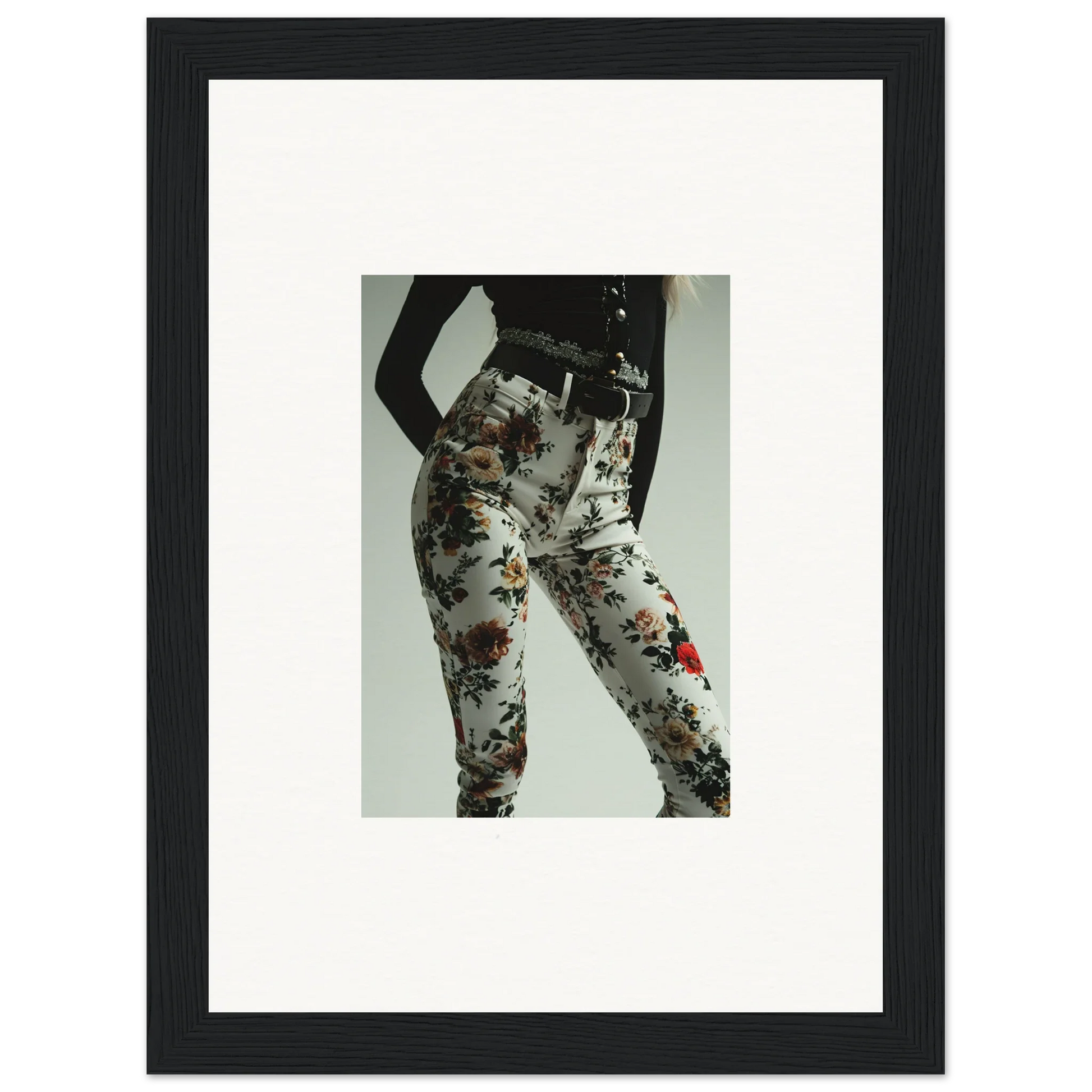 Framed photograph of a person wearing floral-patterned pants or leggings.