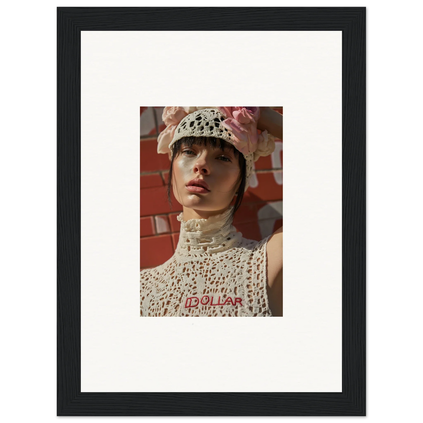 Framed portrait photograph of a person wearing a white crocheted hat and top.