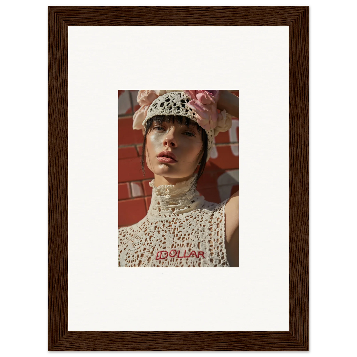 Framed portrait photograph of a person wearing a white crocheted hat and high-necked top.