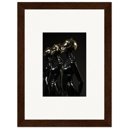 Framed photograph of shiny metallic humanoid figures in dark, sleek outfits.