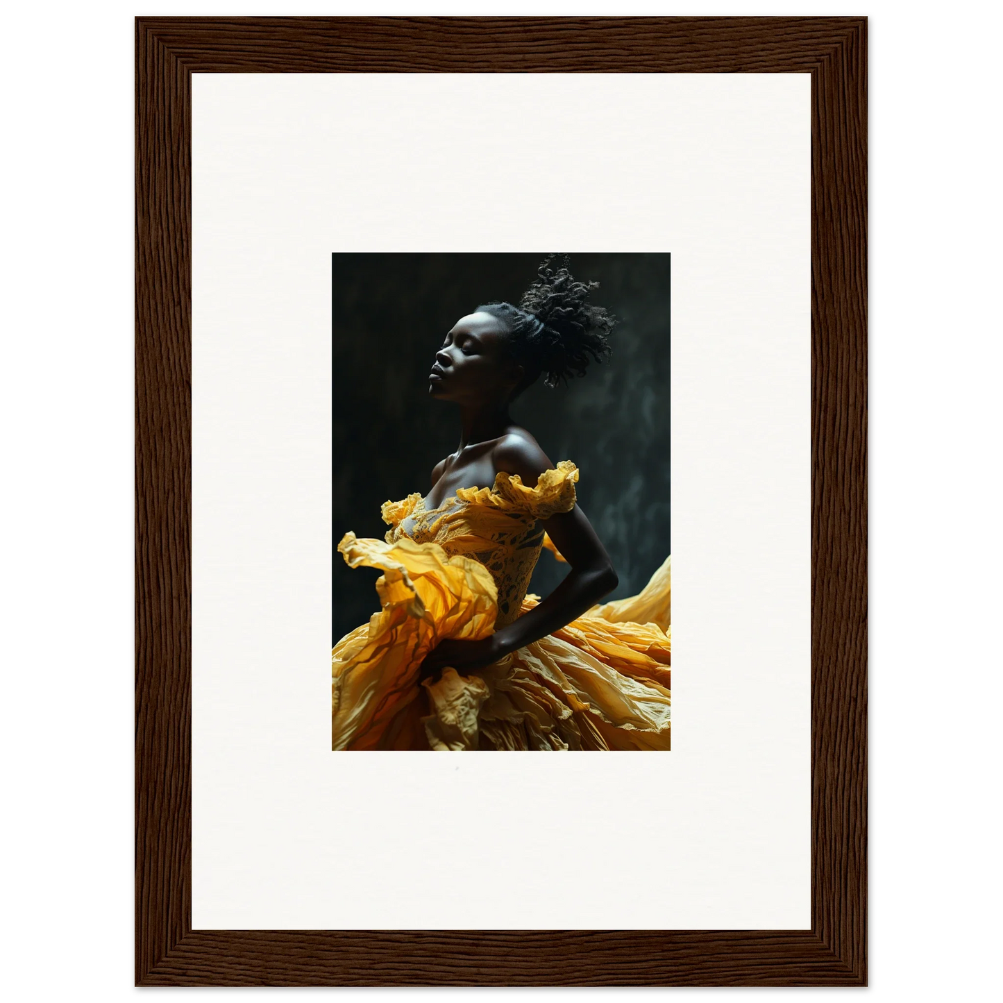 Framed photograph of a person wearing a flowing yellow garment against a dark background.