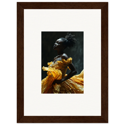 Framed photograph of a person wearing a flowing yellow garment against a dark background.