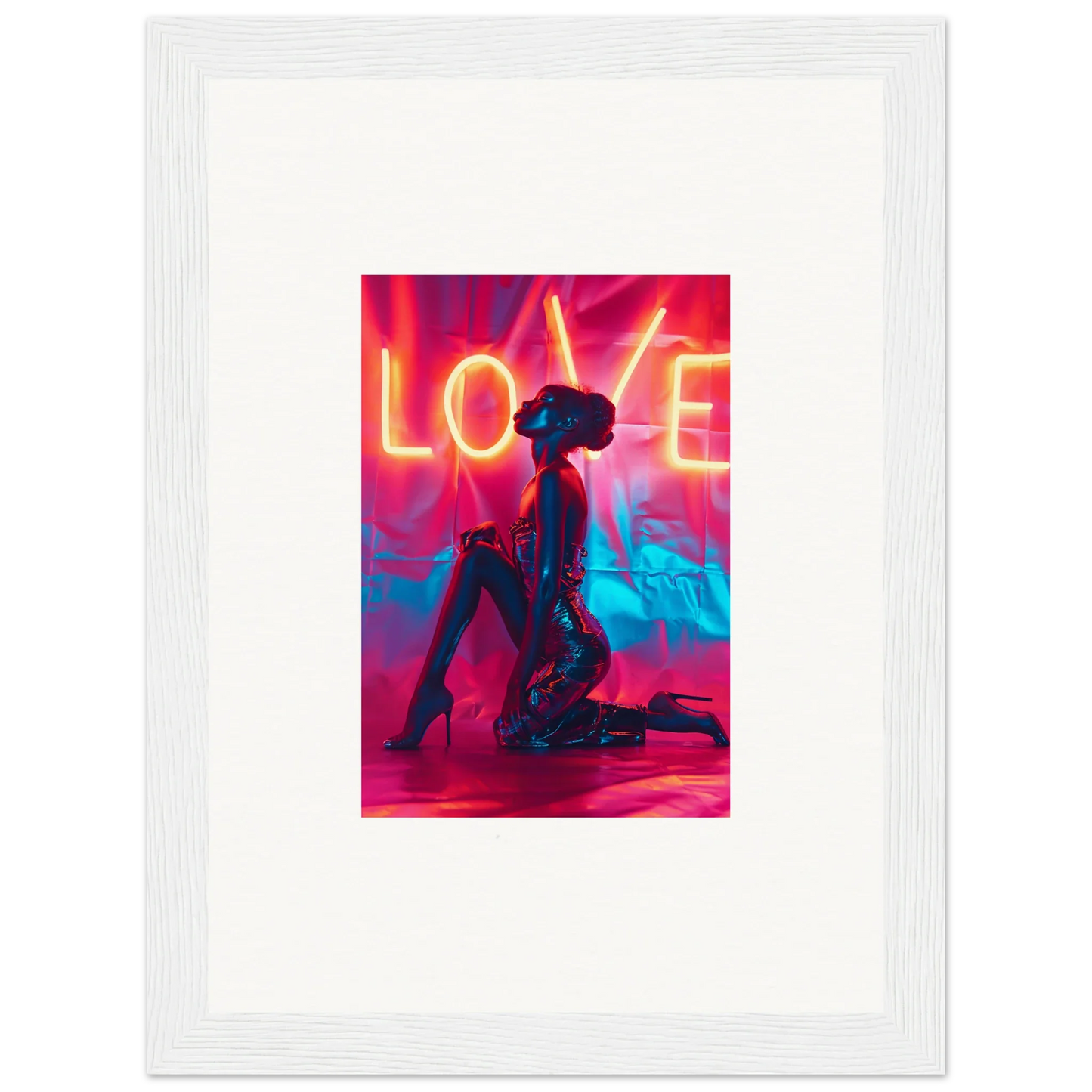 Silhouetted figure kneeling under neon LOVE text, perfect for vibrant wall art decor