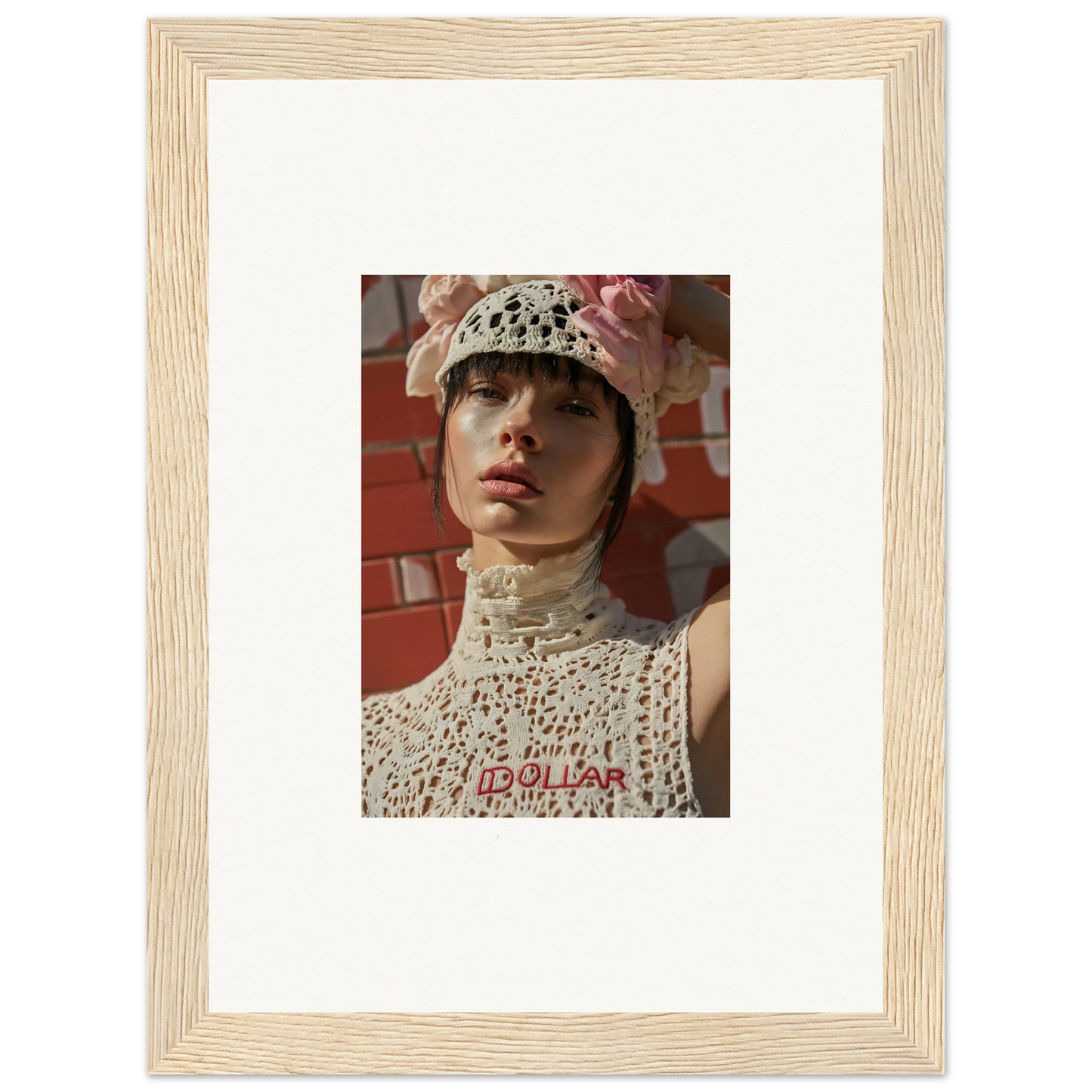 Framed photograph of a person wearing a white crocheted hat and top.