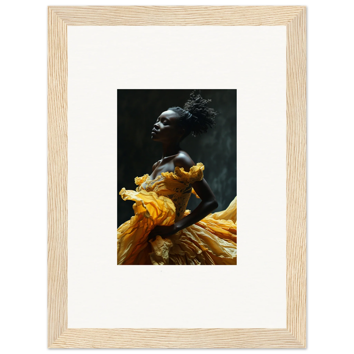 Framed photograph of a person wearing a flowing yellow garment against a dark background.