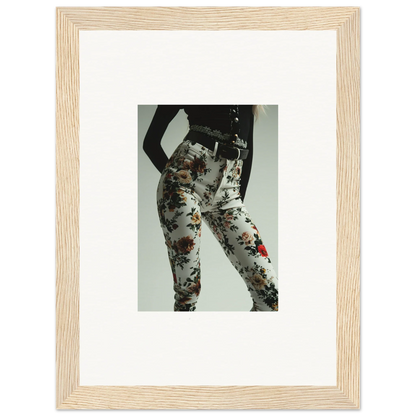 Framed photograph of a person wearing floral-patterned pants or leggings.