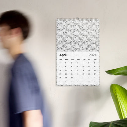 A man is walking past a wall with a Crochet Patterns Wall Calendar: A Year-Round Inspiration for Crochet Enthusiasts on it.