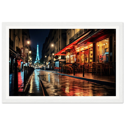 Illuminated Eiffel Tower visible at night from a Parisian street lined with cafes and glowing streetlights.