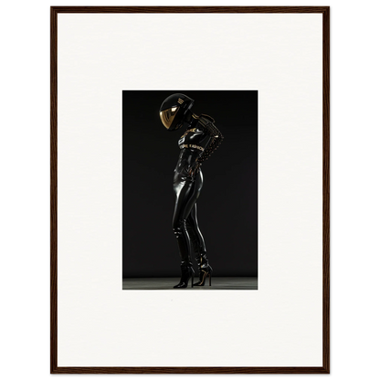 Framed photograph of a person in a shiny black bodysuit and helmet posing dramatically.