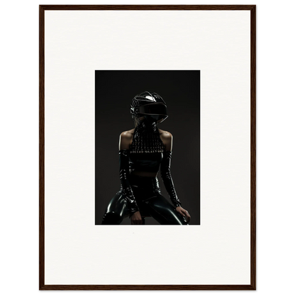 Framed photograph of a person wearing a black helmet and dark clothing in a shadowy, dramatic pose.