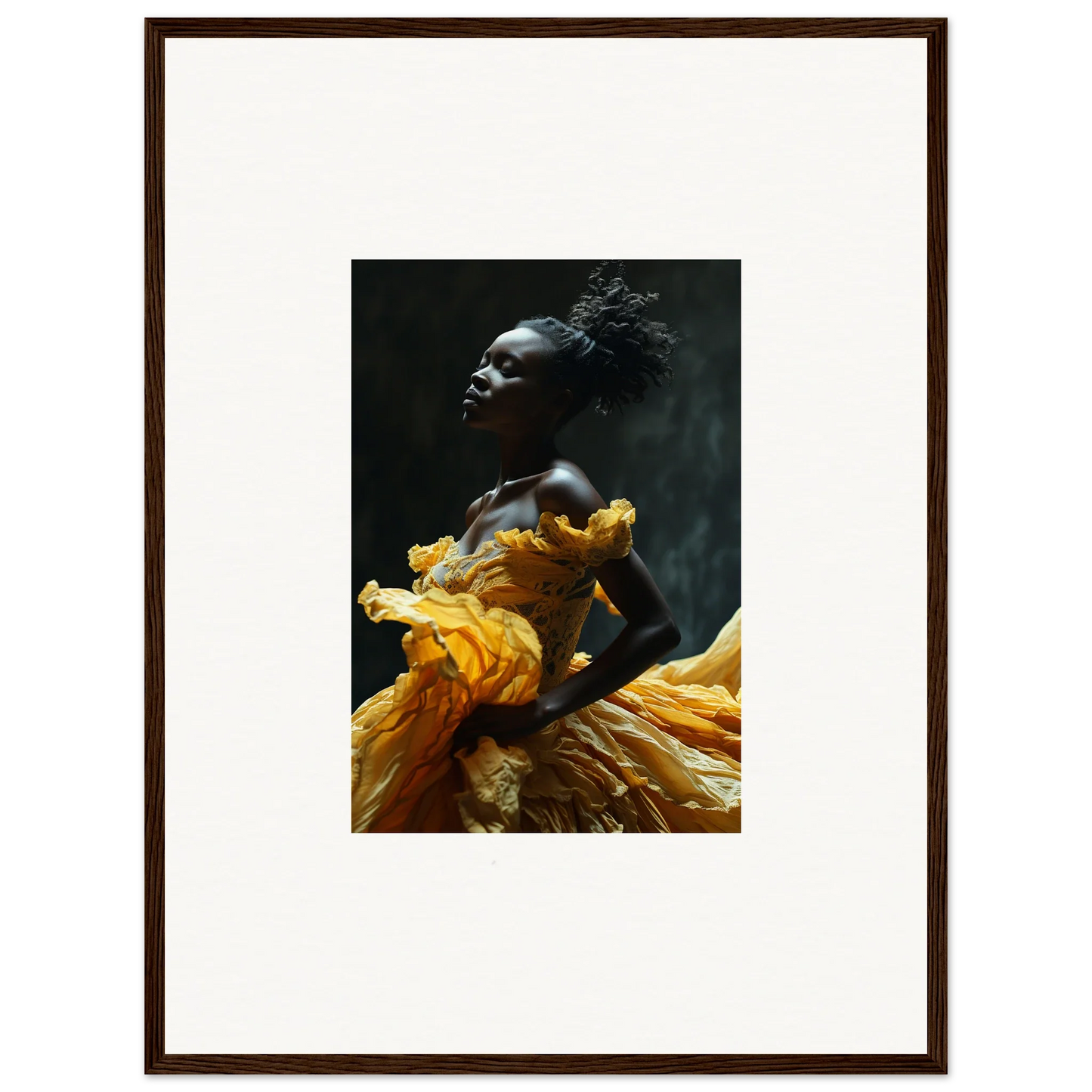 Striking portrait of a person wearing a vibrant yellow garment against a dark background.