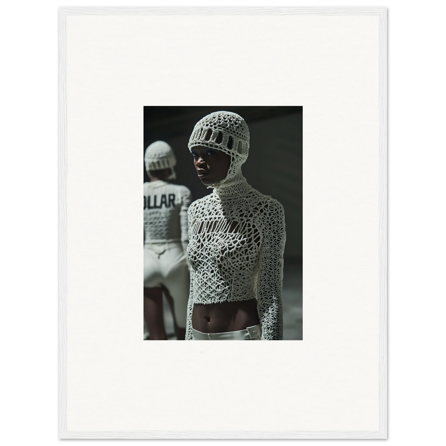 Black and white photograph of a person wearing an intricate crocheted top and hat.