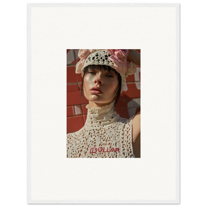 Portrait photograph of a person wearing a white crocheted hat and top against a reddish background.