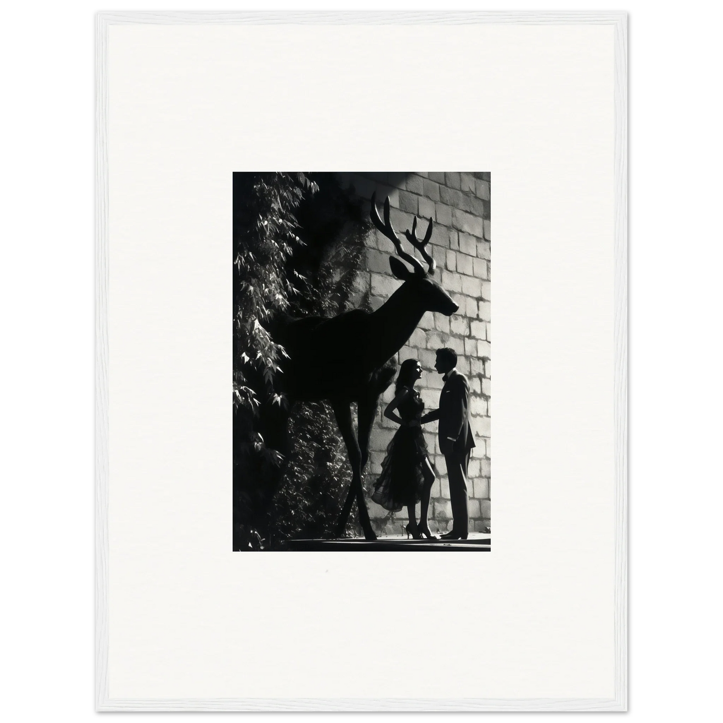 Black and white photograph showing silhouettes of two people and a deer against a brick wall.