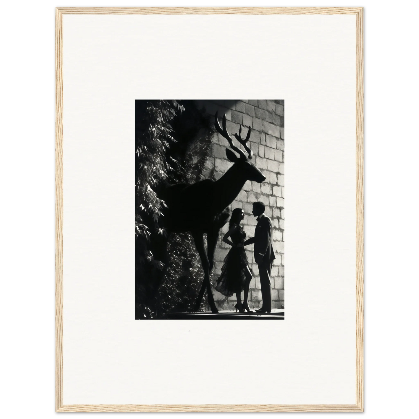 Black and white photograph showing silhouettes of two people and a deer against a brick wall.