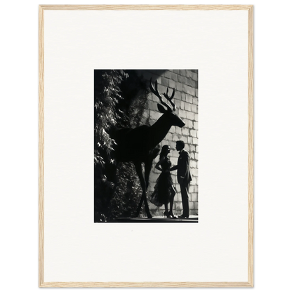 Black and white photograph showing silhouettes of two people and a deer against a brick wall.