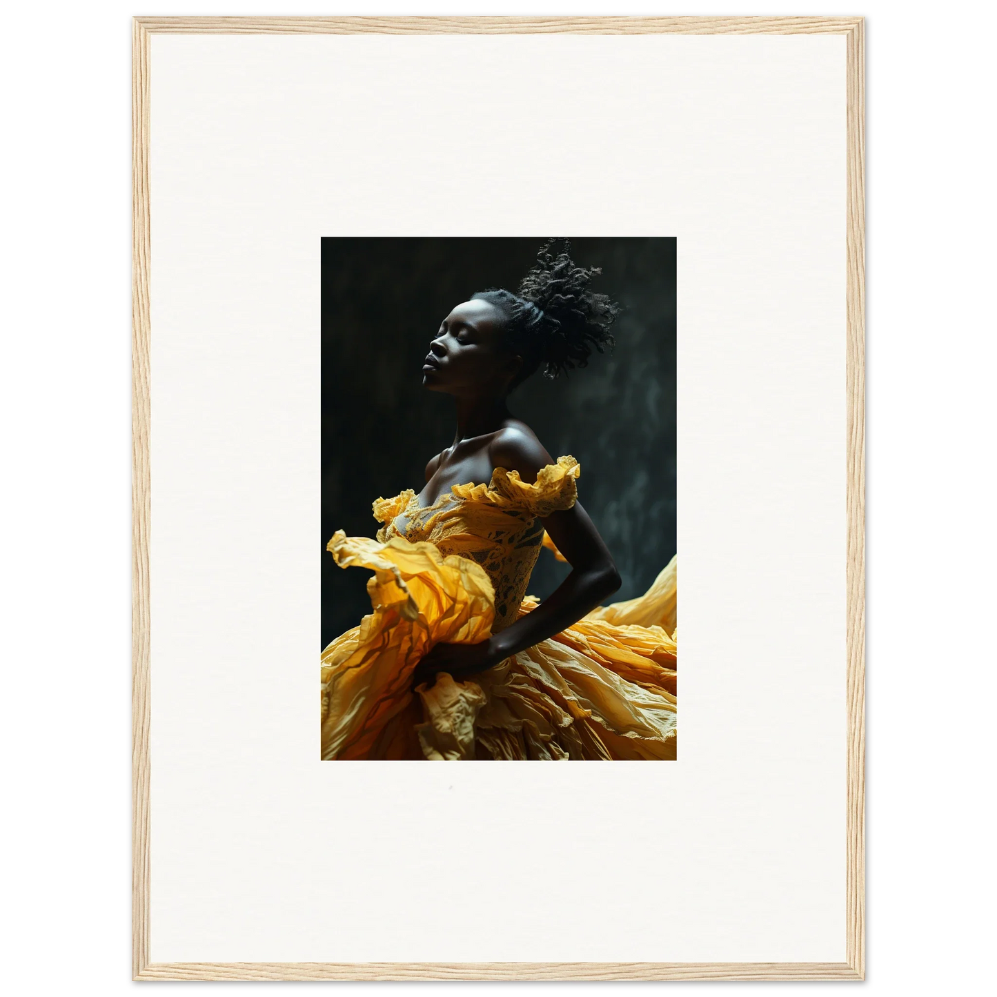 Striking portrait of a person wearing a vibrant yellow garment against a dark background.