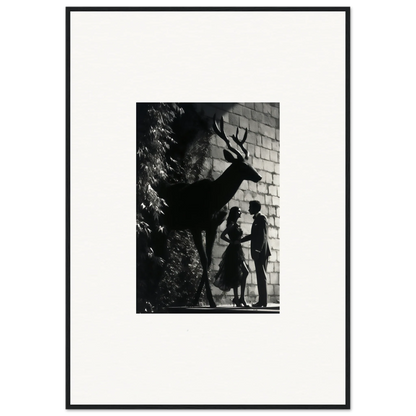 Black and white photograph showing silhouettes of a deer and two people against a brick wall.