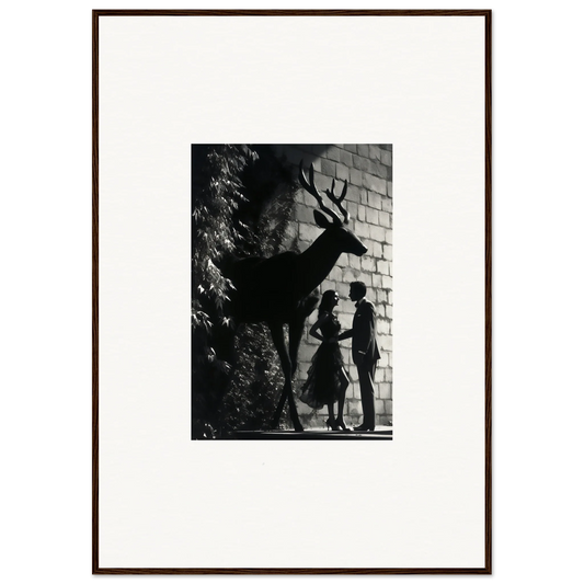 Black and white photograph of a deer’s shadow cast on a brick wall alongside silhouettes of two people.