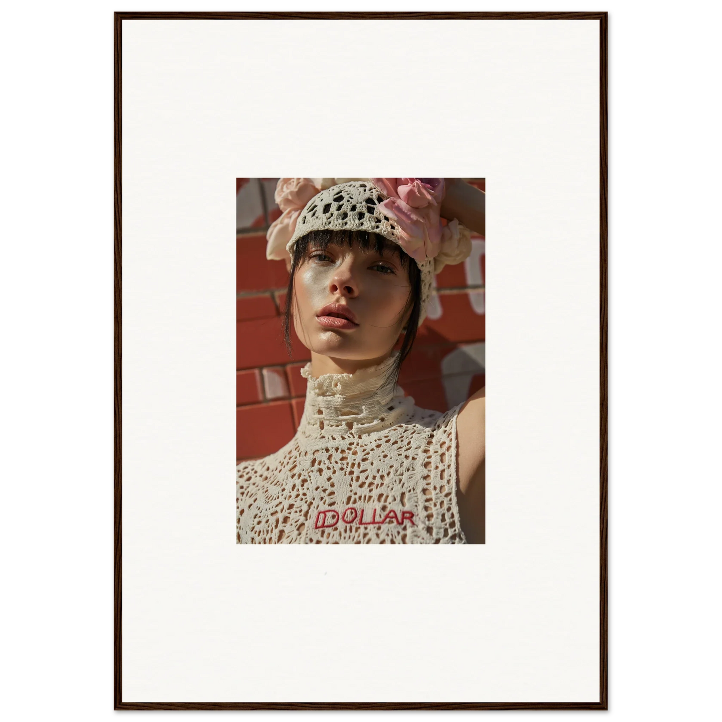 Framed portrait photograph of a person wearing a white crocheted hat and top.