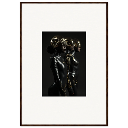 Framed black and white photograph of shiny metallic figures in dramatic poses.