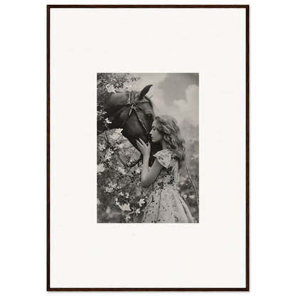 Framed black and white photo of girl kissing a donkey for room decoration