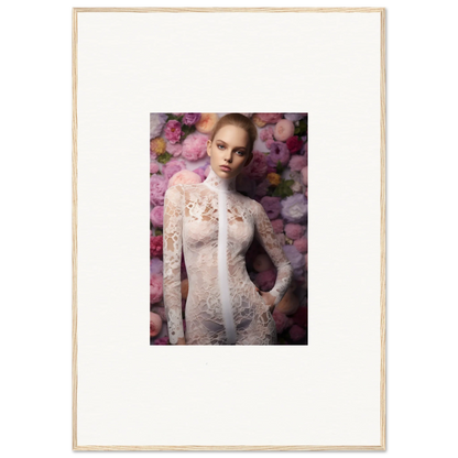 Portrait of a woman in a delicate white lace dress surrounded by pink flowers.