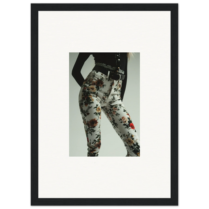 Framed black-and-white photograph of a person’s lower body wearing floral-patterned pants.