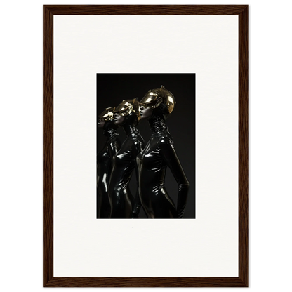 Framed photograph of shiny metallic humanoid figures in dark, dramatic lighting.