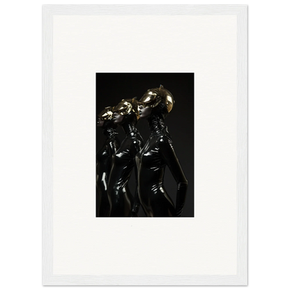 Framed photograph of figures in shiny black outfits posing dramatically.