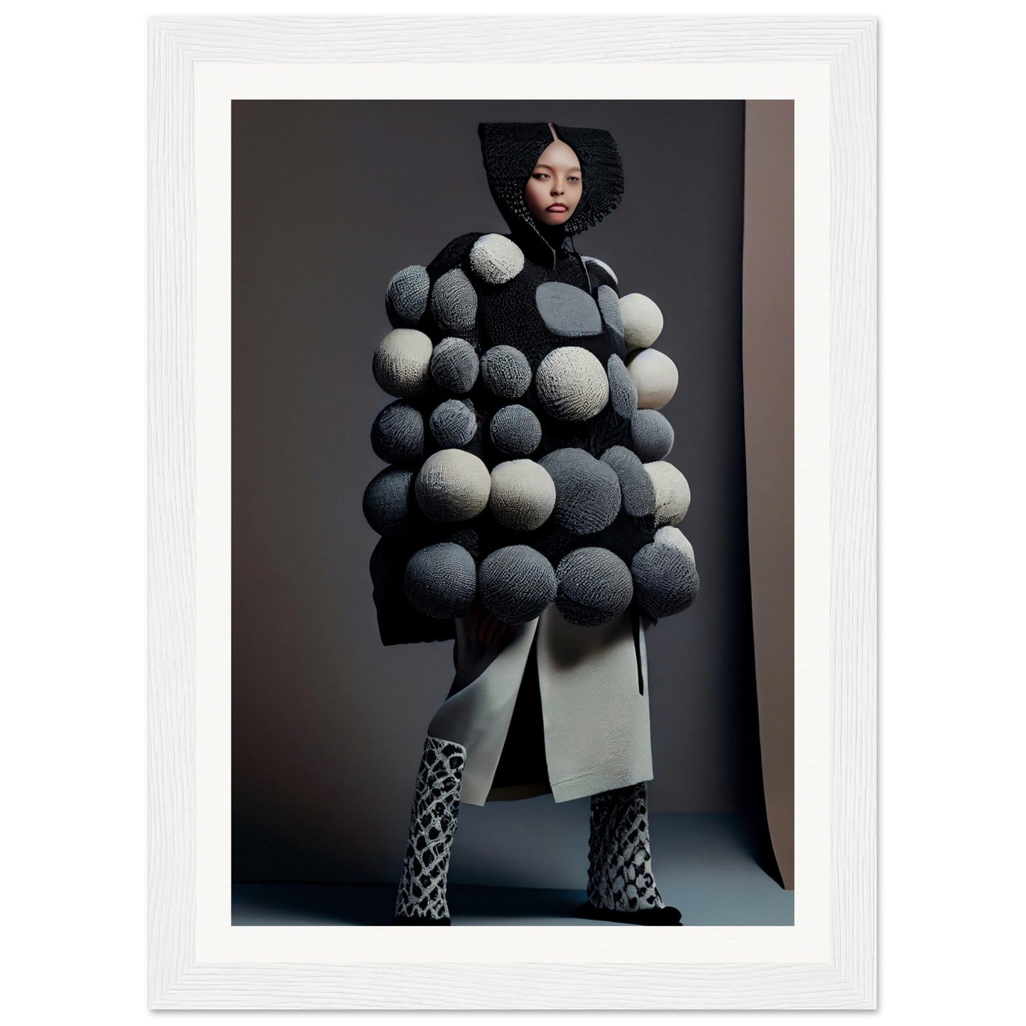 Avant-garde coat adorned with oversized black and white spherical pom-poms.