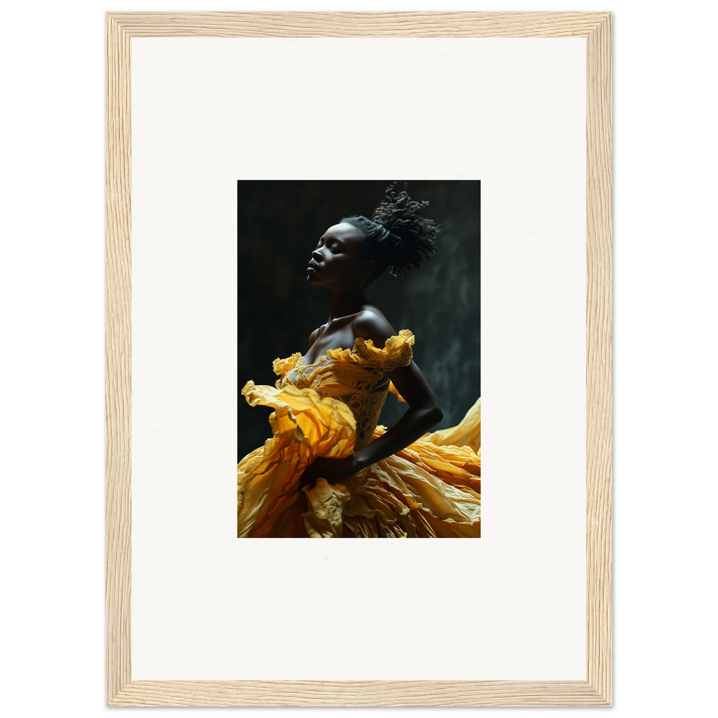 Framed photograph of a person wearing a flowing yellow garment against a dark background.