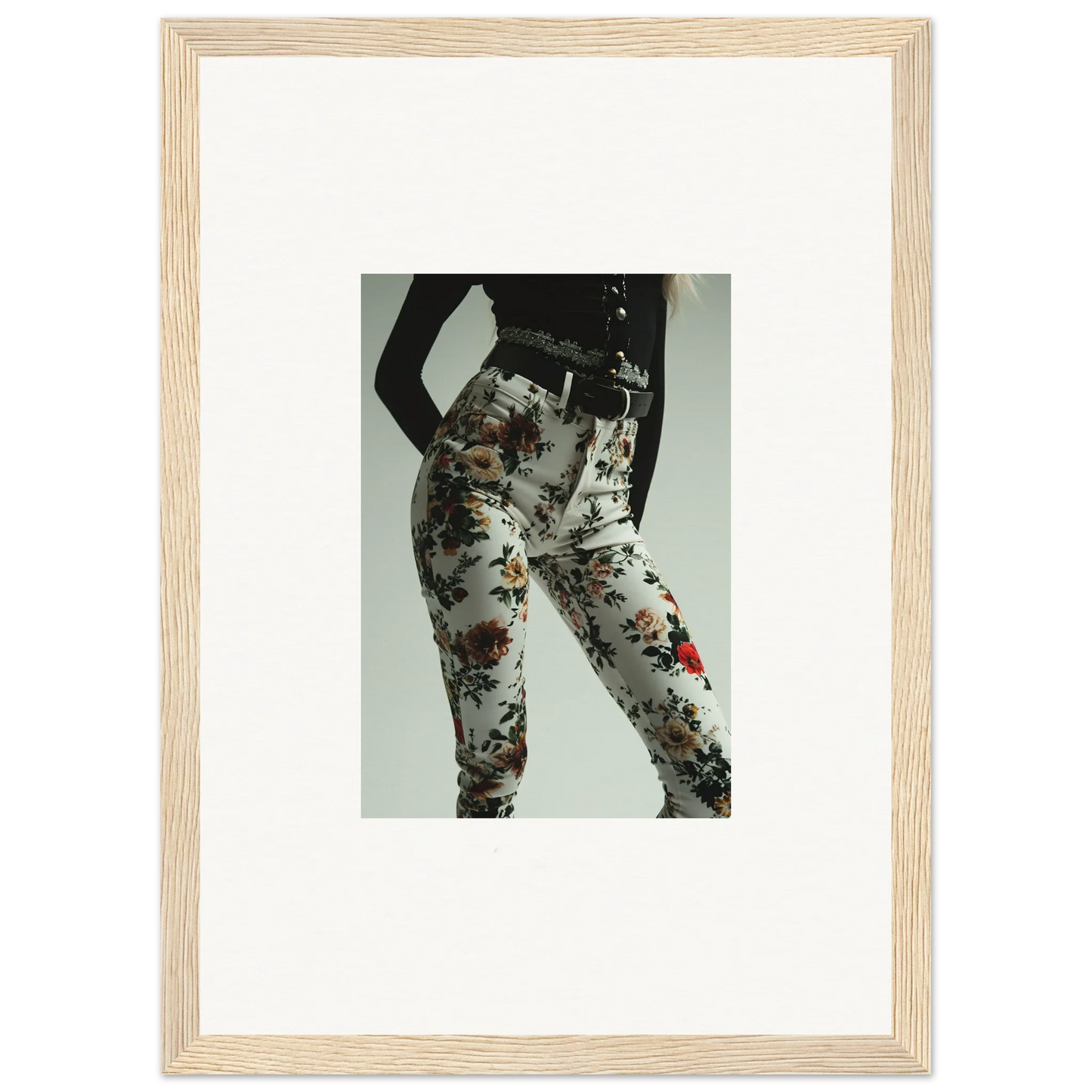 Framed photograph of a person wearing floral-patterned pants.