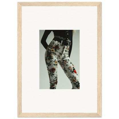 Framed photograph of a person wearing floral-patterned pants.