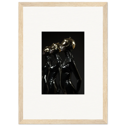 Framed photograph of shiny, metallic humanoid figures in dark, reflective outfits.