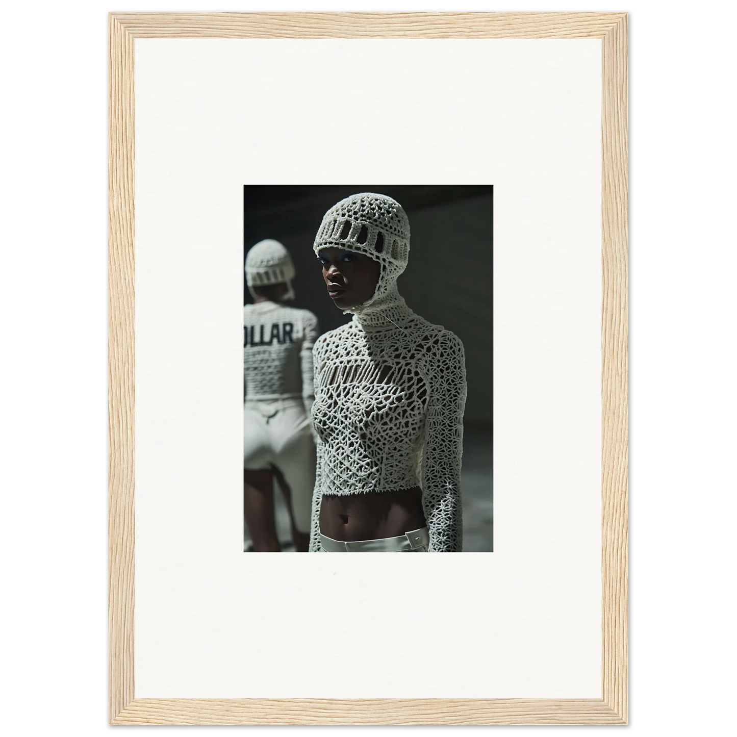 Black and white photograph of a person wearing an intricately patterned, mesh-like top and helmet.