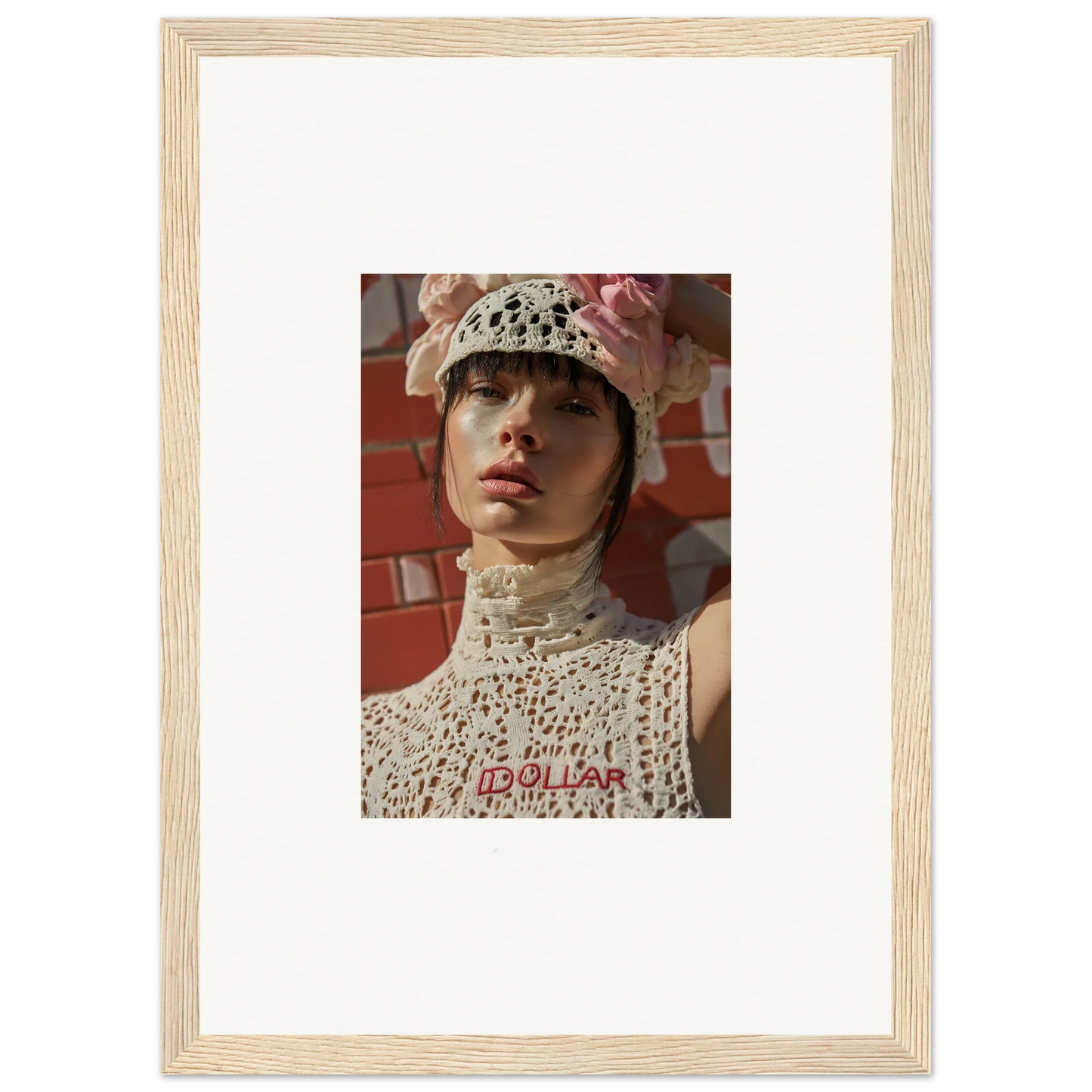 Framed portrait photograph of a person wearing a white crocheted hat and high-necked top.