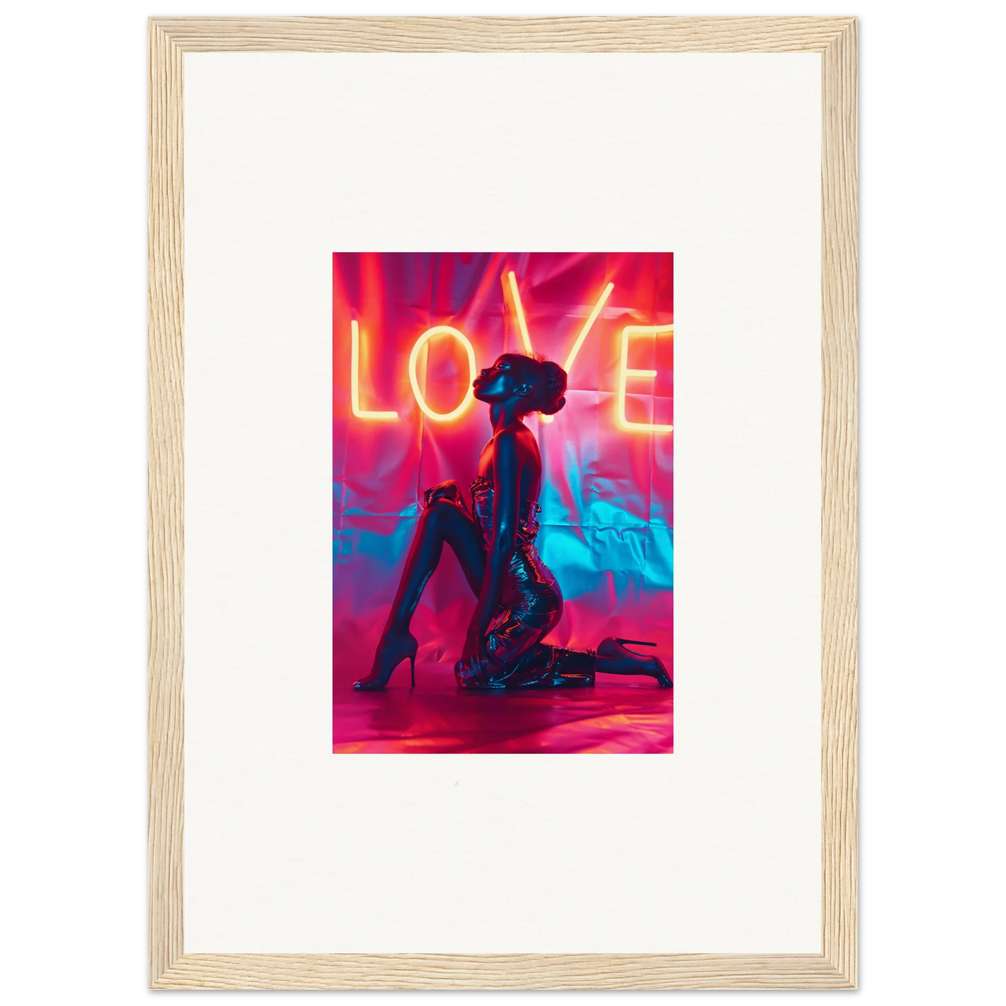 Framed wall art of a kneeling figure under neon LOVE text in vibrant colors for room decoration