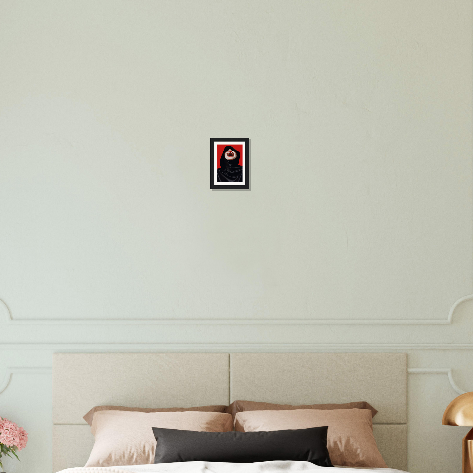 A bed with a white headboard and a red and black pillow