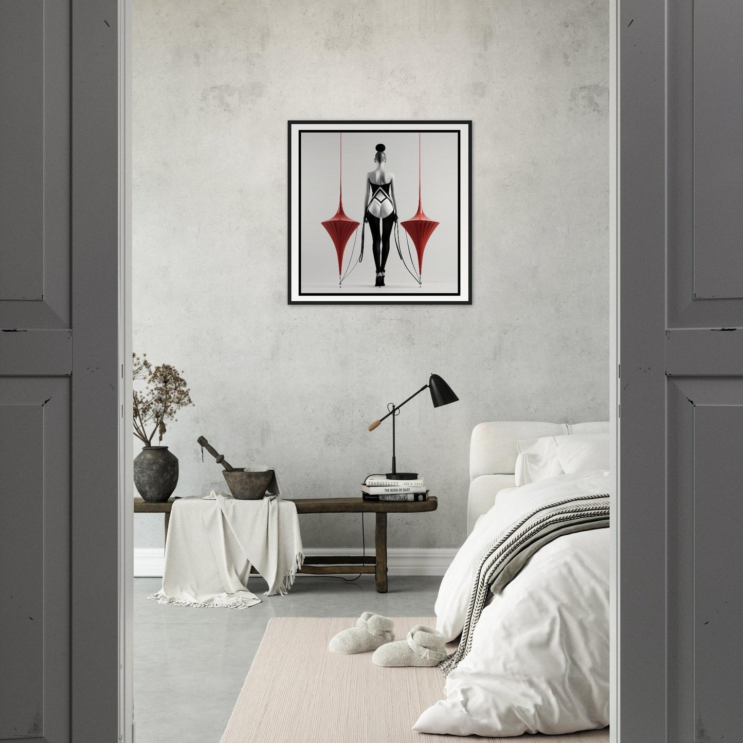 A bedroom with a bed, a chair and a framed print