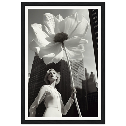 A black and white photo of a woman holding a large flower