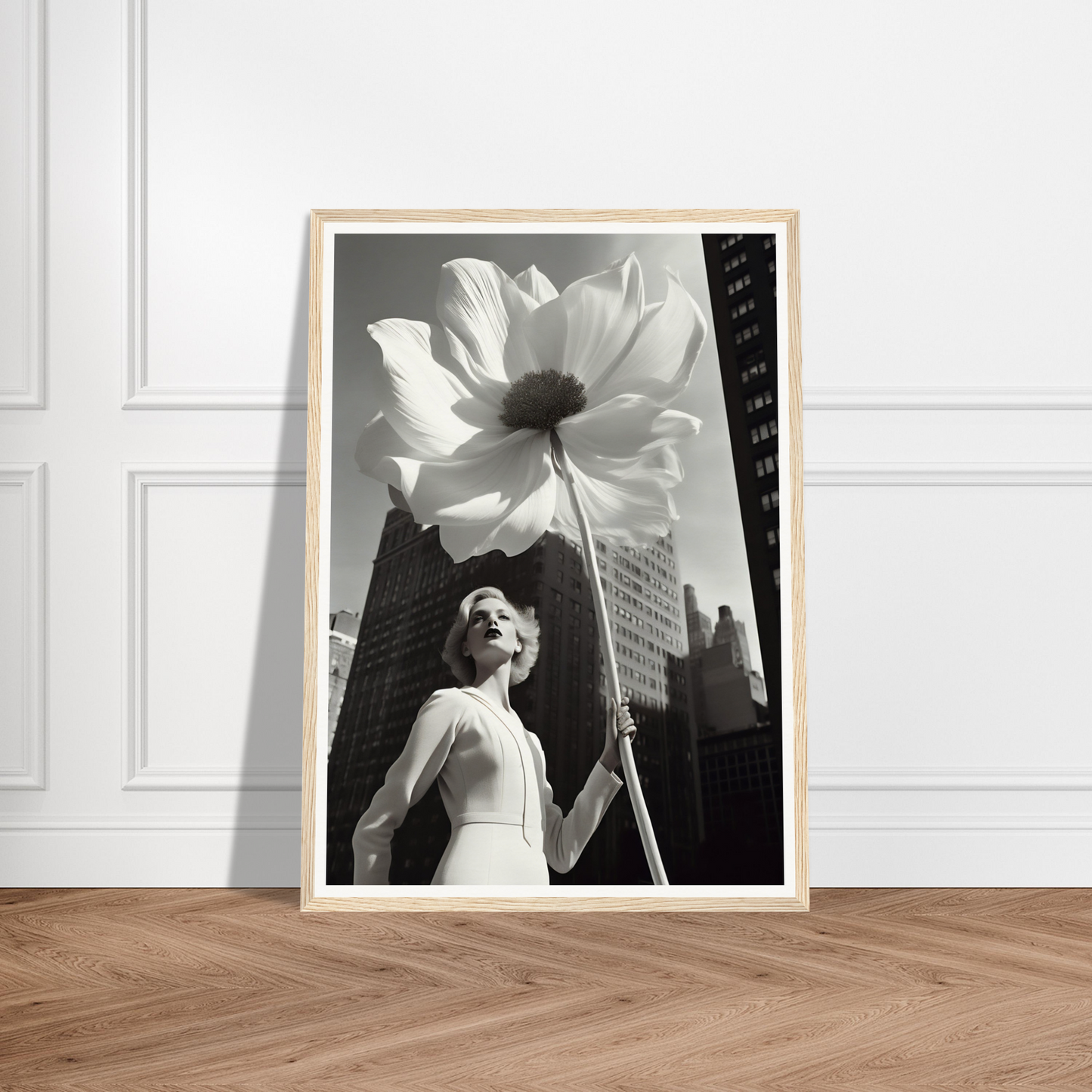 A black and white photo of a woman holding a large white flower