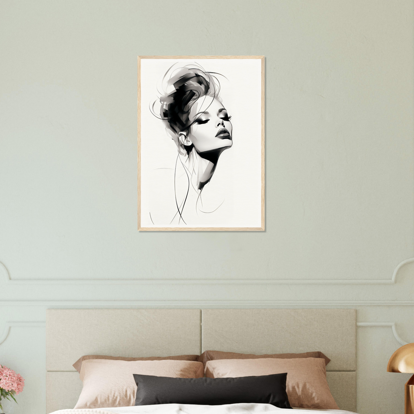 A black and white drawing of a woman’s face on a wall above a bed