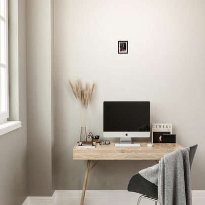 Wooden desk with a computer monitor and minimalist decor.