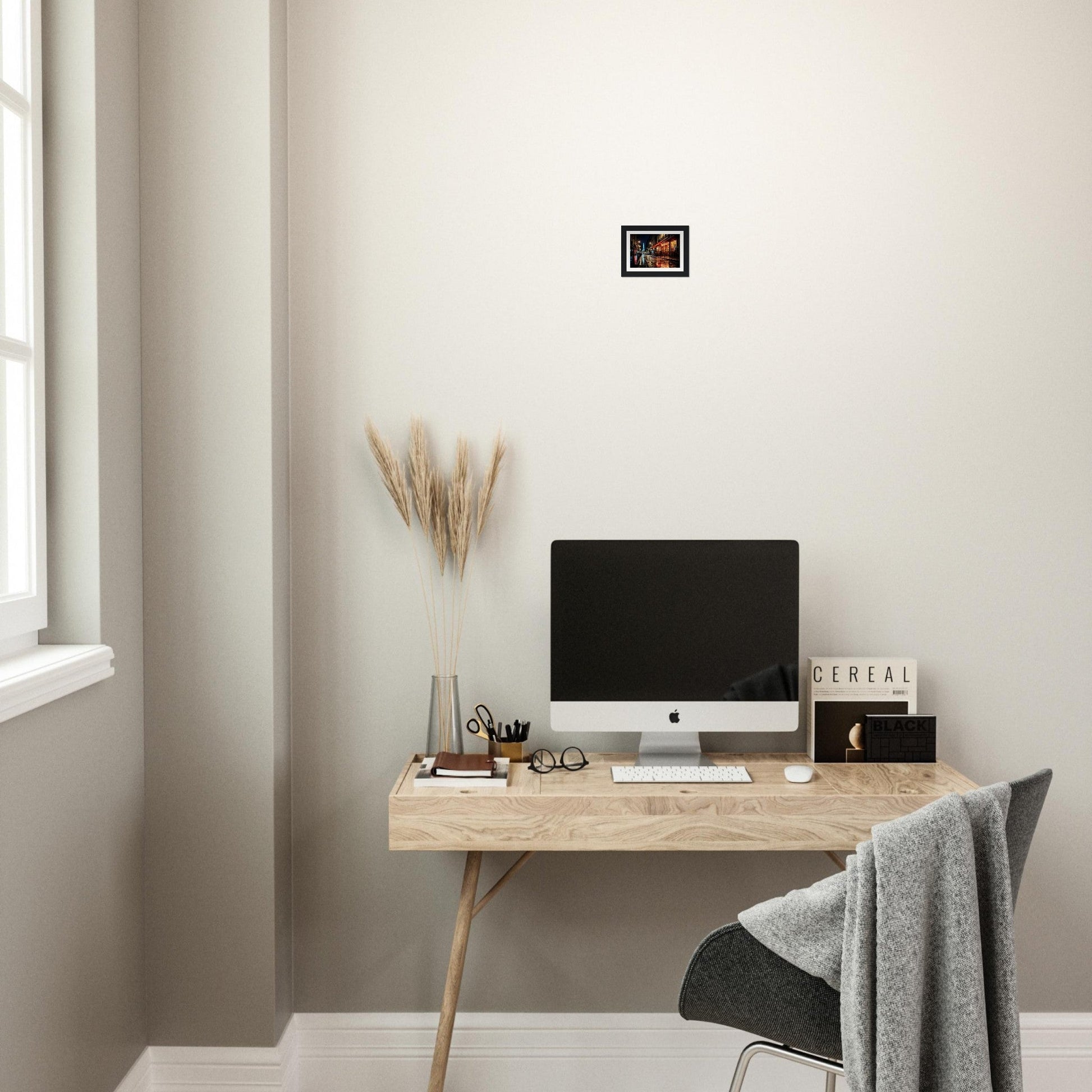 Minimalist wooden desk with a computer monitor and office accessories.