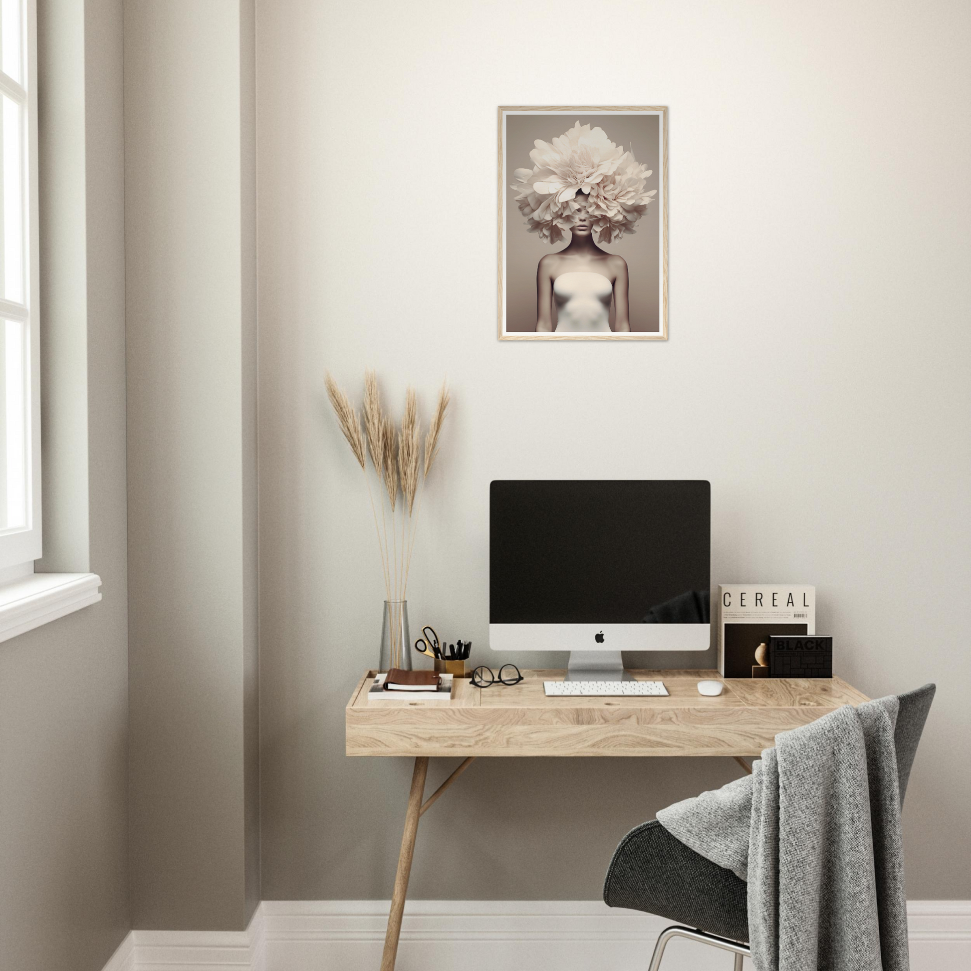 Minimalist wooden desk with a computer monitor and decorative accessories.