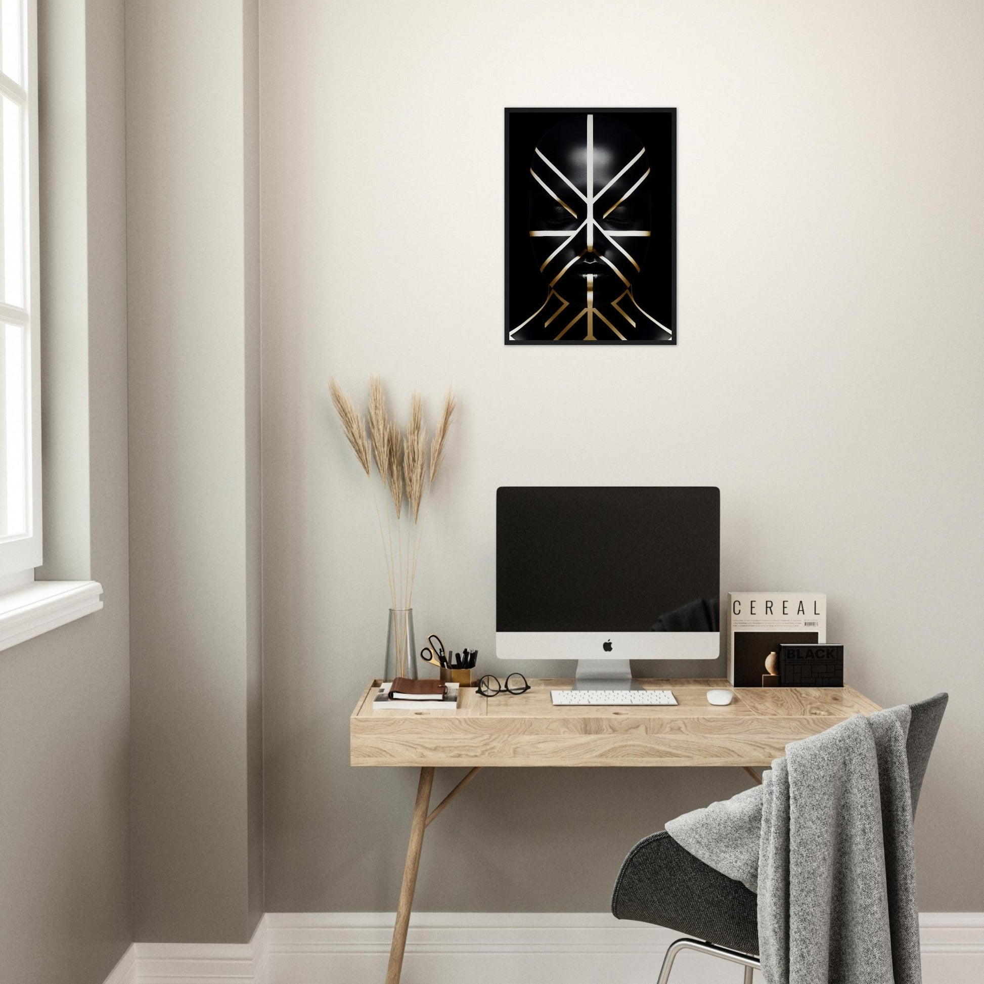 Minimalist home office workspace with a wooden desk, computer, and decorative wall art.