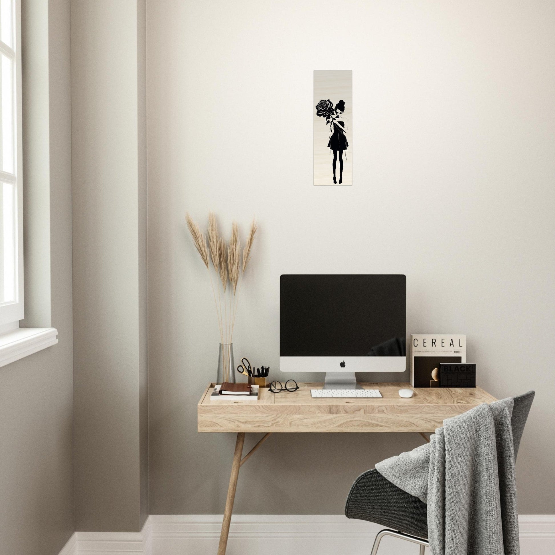 Minimalist wooden desk with a computer monitor and office accessories.