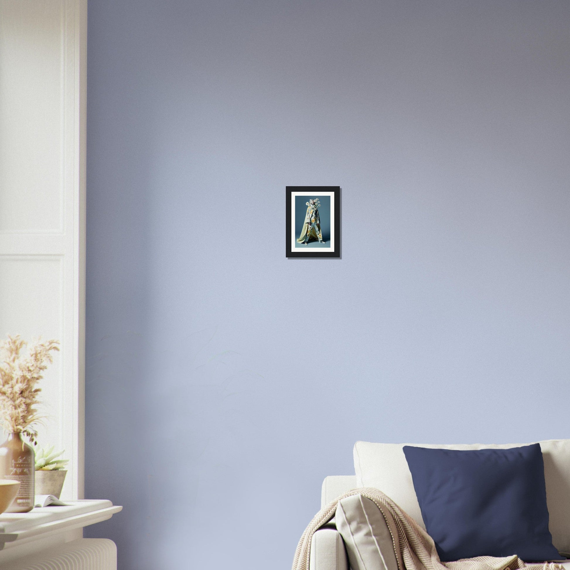 Framed artwork of a religious figure hanging on a pale blue wall.